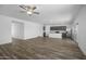Expansive living area featuring wood-look flooring, an open layout, and views into the kitchen at 6486 S 246Th Ln, Buckeye, AZ 85326