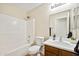 This bathroom features a shower-tub combo and a single-sink vanity with storage at 37108 W Bello Ln, Maricopa, AZ 85138