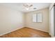 Neutral bedroom with light walls, wood-look floors and a ceiling fan at 37108 W Bello Ln, Maricopa, AZ 85138