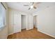 Bedroom with wood-look flooring and closet with sliding doors at 37108 W Bello Ln, Maricopa, AZ 85138