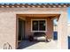 Covered back patio features comfortable seating, a garden, and seamless indoor-outdoor living at 37108 W Bello Ln, Maricopa, AZ 85138