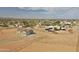 Expansive aerial view showcases the desert home with a fenced yard and community views at 22378 W Gamble Ln, Wittmann, AZ 85361