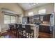 Spacious kitchen featuring stainless steel appliances, granite countertops, and seating at the island at 10402 E Saltillo Dr, Scottsdale, AZ 85255