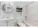 Bright bathroom features a white vanity, toilet, and shower-tub combo, providing a clean and functional space at 4032 W Reade Ave, Phoenix, AZ 85019