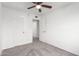 Neutral bedroom with wall-to-wall carpeting, a ceiling fan, and access to the en suite bathroom at 4032 W Reade Ave, Phoenix, AZ 85019