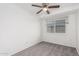 This charming bedroom features neutral carpet, a ceiling fan, and a window at 4032 W Reade Ave, Phoenix, AZ 85019