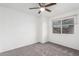 Bedroom featuring plush carpeting, ceiling fan, and a window offering natural light at 4032 W Reade Ave, Phoenix, AZ 85019