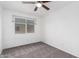 Bright bedroom with a large window and neutral carpeting at 4032 W Reade Ave, Phoenix, AZ 85019