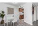 Bright dining area featuring a modern white table and chairs, complemented by stylish decor and wood-look floors at 4032 W Reade Ave, Phoenix, AZ 85019