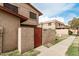 This townhome has a privacy fence with a wooden door with the address posted at 4032 W Reade Ave, Phoenix, AZ 85019