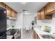 Open kitchen view featuring stainless steel appliances, white countertops, dining table, and wood-look flooring at 4032 W Reade Ave, Phoenix, AZ 85019