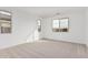 Bright bedroom with neutral carpeting and large windows at 40503 W Wade Dr, Maricopa, AZ 85138