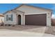 Front view of charming home with a two-car garage at 40503 W Wade Dr, Maricopa, AZ 85138