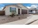 Front view of charming home with a two-car garage at 40503 W Wade Dr, Maricopa, AZ 85138