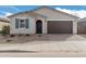 New single-story home with two-car garage and desert landscaping at 40503 W Wade Dr, Maricopa, AZ 85138