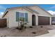 Front view of charming home with a two-car garage at 40503 W Wade Dr, Maricopa, AZ 85138