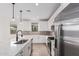 Modern kitchen with white cabinets and stainless steel appliances at 40503 W Wade Dr, Maricopa, AZ 85138