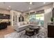 Bright living room featuring a sectional sofa, round coffee tables and a sliding glass door leading to a patio at 38500 N School House Rd # 42, Cave Creek, AZ 85331