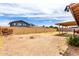 Expansive backyard features a brick fireplace, a dirt ground, and a covered patio area at 5625 N 47Th Ave, Glendale, AZ 85301