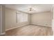 Bedroom with hardwood floors, ceiling fan and a window with coverings for filtered light at 5625 N 47Th Ave, Glendale, AZ 85301