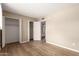 This is a bedroom with wood floors and an open closet at 5625 N 47Th Ave, Glendale, AZ 85301