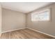 This bedroom features wood flooring and a window with lots of natural light at 5625 N 47Th Ave, Glendale, AZ 85301