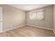 This bedroom features wood flooring and a window at 5625 N 47Th Ave, Glendale, AZ 85301