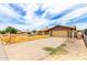 View of the home with a long driveway leading to the attached garage plus desert landscaping at 5625 N 47Th Ave, Glendale, AZ 85301