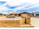 Tan home featuring an attached garage and mature landscaping out front with a decorative wall at 5625 N 47Th Ave, Glendale, AZ 85301