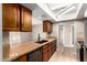 The kitchen features stainless steel appliances, stone countertops, and wood cabinets at 5625 N 47Th Ave, Glendale, AZ 85301