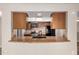 The kitchen features stainless steel appliances, stone countertops, and updated fixtures at 5625 N 47Th Ave, Glendale, AZ 85301
