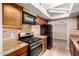 The kitchen features stainless steel appliances, stone countertops, and wood cabinets at 5625 N 47Th Ave, Glendale, AZ 85301