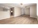 Open-concept living room featuring hardwood floors with steps up to the kitchen and bathroom at 5625 N 47Th Ave, Glendale, AZ 85301