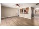Bright living room with ceiling fan, view to the kitchen and wood-look flooring at 5625 N 47Th Ave, Glendale, AZ 85301