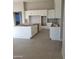 Spacious kitchen with white cabinets, an island, and light-colored tile flooring at 1973 W Brooke Ln, Queen Creek, AZ 85144