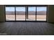 Living room with sliding glass doors offering scenic views of the backyard and mountains at 1973 W Brooke Ln, Queen Creek, AZ 85144