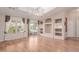 Bright living room features hardwood floors, modern lighting, and built-in shelving at 2550 S Ellsworth Rd # 366, Mesa, AZ 85209