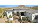 Inviting front entry with stone pillars, desert landscaping, and mountain views in the background at 25583 N 89Th St, Scottsdale, AZ 85255