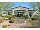 Charming front exterior with stone accents, a brick walkway, and lush desert landscaping at 25583 N 89Th St, Scottsdale, AZ 85255