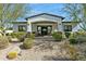 Charming front exterior with stone accents, a brick walkway, and lush desert landscaping at 25583 N 89Th St, Scottsdale, AZ 85255