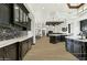 Bright, open kitchen featuring black cabinets, large island, and views into the living room at 25583 N 89Th St, Scottsdale, AZ 85255