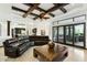 Open-concept living room with exposed beams, modern ceiling fan, and views to the kitchen and outdoors at 25583 N 89Th St, Scottsdale, AZ 85255