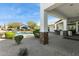 Beautiful outdoor kitchen with stone accents, bar seating, and a view of the pool and backyard at 25583 N 89Th St, Scottsdale, AZ 85255