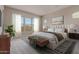 Serene bedroom showcasing a king-size bed, plush bedding, and natural light, creating a relaxing atmosphere at 20755 W San Miguel Ave, Buckeye, AZ 85396