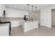 Modern kitchen featuring white cabinets, quartz countertops, and stainless steel appliances at 19637 W Cartwright Ave, Buckeye, AZ 85396