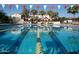 Community lap pool with flags and palm trees at 19781 W Exeter Blvd, Litchfield Park, AZ 85340