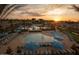 Sunset view of resort-style pool with lounge chairs at 19781 W Exeter Blvd, Litchfield Park, AZ 85340