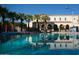 Community pool with palm trees and building reflection at 19781 W Exeter Blvd, Litchfield Park, AZ 85340