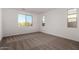 Bright bedroom with neutral walls and brown carpet at 40532 W Wade Dr, Maricopa, AZ 85138