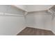 Large walk-in closet with wood shelving and carpet flooring at 40532 W Wade Dr, Maricopa, AZ 85138